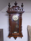 A 19th century mahogany cased wall clock with pendulum and key.