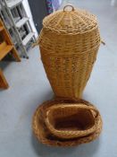 A large wicker lidded laundry basket together with two further wicker baskets.