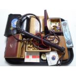 A tray containing polished stones, travel games, playing cards, riding whip, trinket boxes etc.