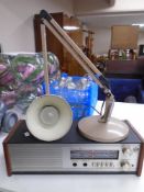A Roberts radio together with an angle poise lamp.