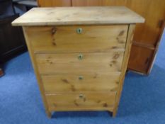 An antique pine four drawer chest.