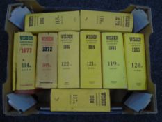 A box containing Wisdens cricket books.