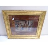 A gilt framed photogravure depicting children in a classroom, 52cm by 44cm.