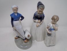 Three Royal Copenhagen figures of a girl with doll,