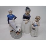 Three Royal Copenhagen figures of a girl with doll,