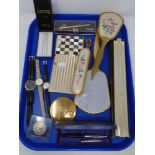 A tray of dressing table items, universal slide rule, commemorative coin, wristwatches,