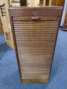 An Edwardian shutter-fronted music cabinet (locked)