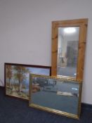 A pine framed hall mirror together with a further gilt framed mirror and an oil-on-board woodland