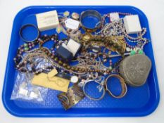 A tray containing assorted costume jewellery including beaded necklaces, bracelets,