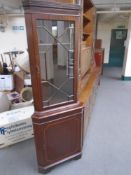 A corner display cabinet fitted with a cupboard beneath in a mahogany finish.