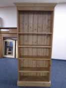 An antique pine open bookcase.