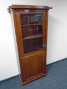 A 19th century mahogany glazed door display cabinet fitted with a cupboard beneath.