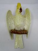 A 19th century Bretby wall pocket in the form of a parrot.