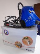A Nilfisk Alto SteamTec 312 steam cleaner with hose and accessories.