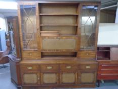 A mahogany bureau bookcase wall unit fitted with cupboards and drawers beneath and leather inset