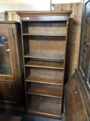 A set of mahogany open bookshelves.