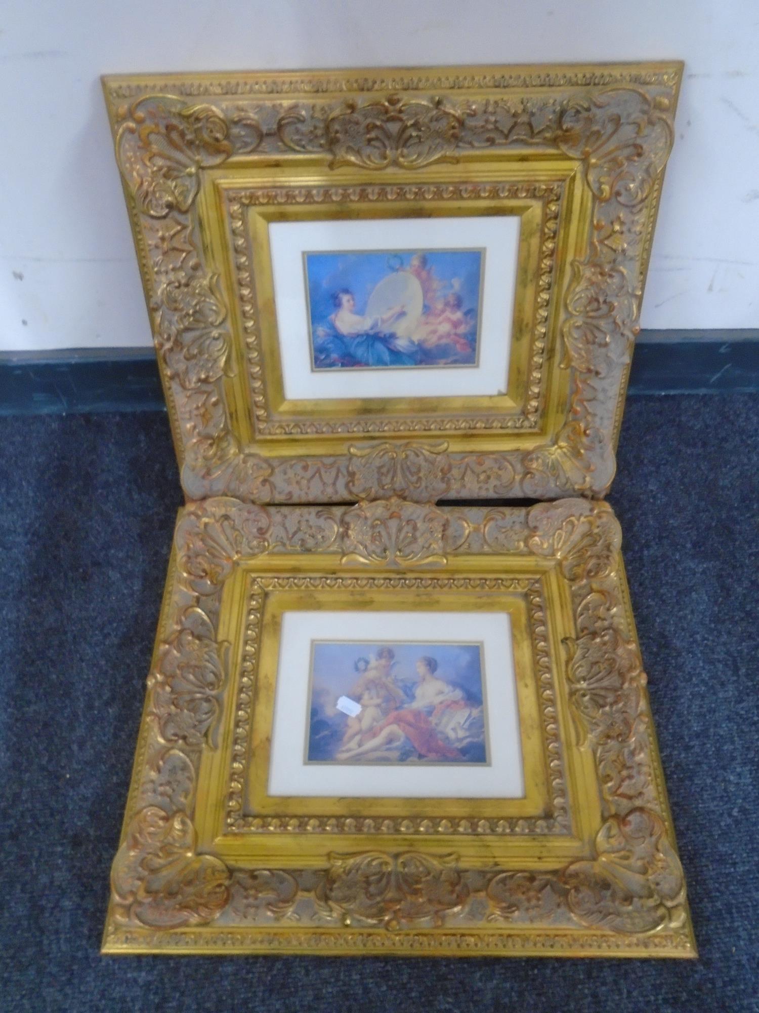 A pair of Victorian style gilt framed prints depicting cherubs.