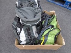 A box containing two Tiso Peak 35 rucksacks together with two further Berghaus backpacks.
