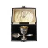 A silver egg cup and spoon, Northern Goldsmiths Co, Birmingham 1931, boxed.