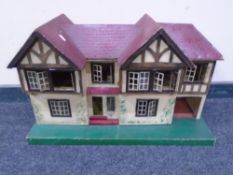 A hand-finished wooden doll's house, together with dolls house furniture and vintage accessories.