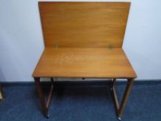 An A H McIntosh & Co teak turnover top trolley, lacking the two nesting tables beneath.