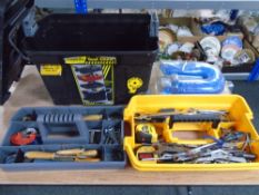 A mobile tool chest containing tools together with an air hose.