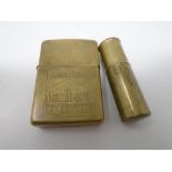 A brass trench art lighter together with a further brass Zippo Marlboro lighter.