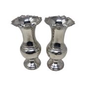 A pair of loaded silver vases, William Comyns & Sons, London 1909, height 15.5cm.
