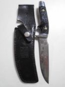 A German Solingen knife in leather sheath.
