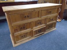 A rustic pine eight drawer chest