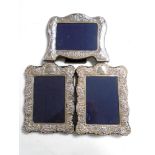 Three silver photograph frames.