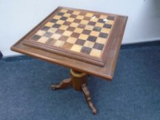 A chess board pedestal occasional table