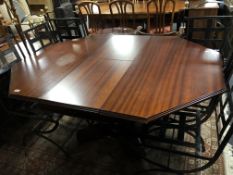 An octagonal extending pedestal dining table in a mahogany finish.