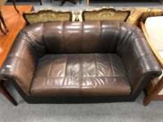 A brown leather club settee