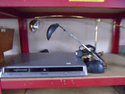 A Panasonic DVD recorder together with two angle poise table lamps on weighted bases.
