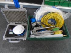 A plastic crate containing wires, 110v sockets,