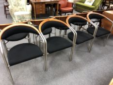 A set of four Sorensen contemporary armchairs on tubular metal legs