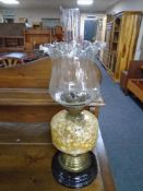 A Victorian oil lamp with coloured glass reservoir,