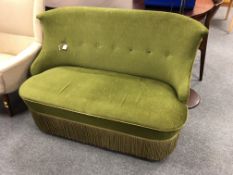 A 1930's Art Deco settee in green fabric