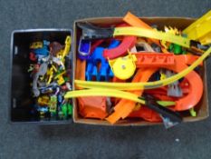 Two boxes containing plastic Hotwheels and other track, together with die cast cars.