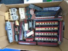 A box containing Hornby rolling stock, carriages, buildings etc.