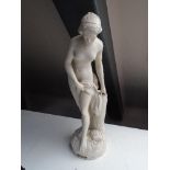 A chalk figure of a lady together with a reproduction mantle clock figure holding a spear