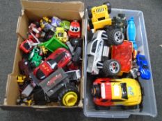 Two boxes containing a large quantity of assorted plastic and die cast cars and vehicles.