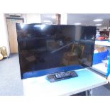 A Samsung 32" LCD TV with remote control.