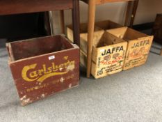 A painted Carlsberg brewery crate together with two further pine Jaffa crates.