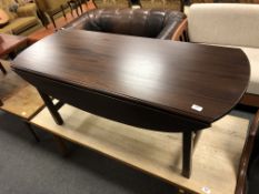 A flap sided coffee table in mahogany finish,