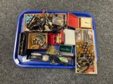 A tray of costume jewellery, bedroom clock,