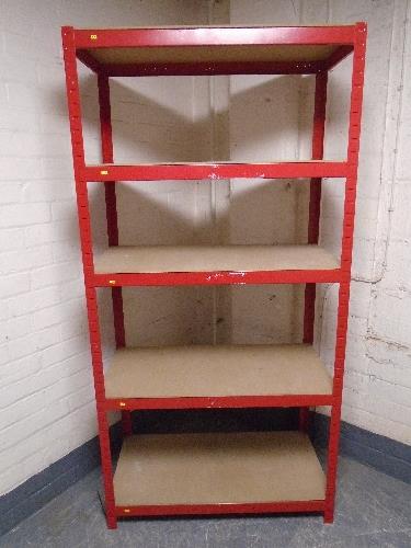 A five tier red metal shelving unit.