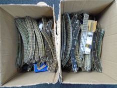 Two boxes containing vintage tin plate OO track.
