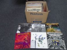 A box containing vinyl records including Thin Lizzy, Diana Ross, Radiohead, Megadeth, Sleaford Mods,